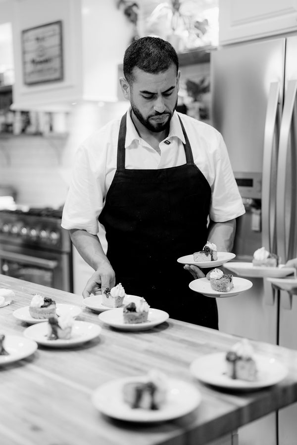 Edgar plating dessert in a client’s kitchen