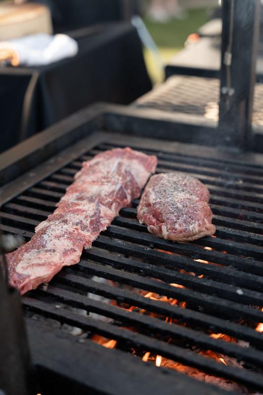 Cuts of beef over open flame